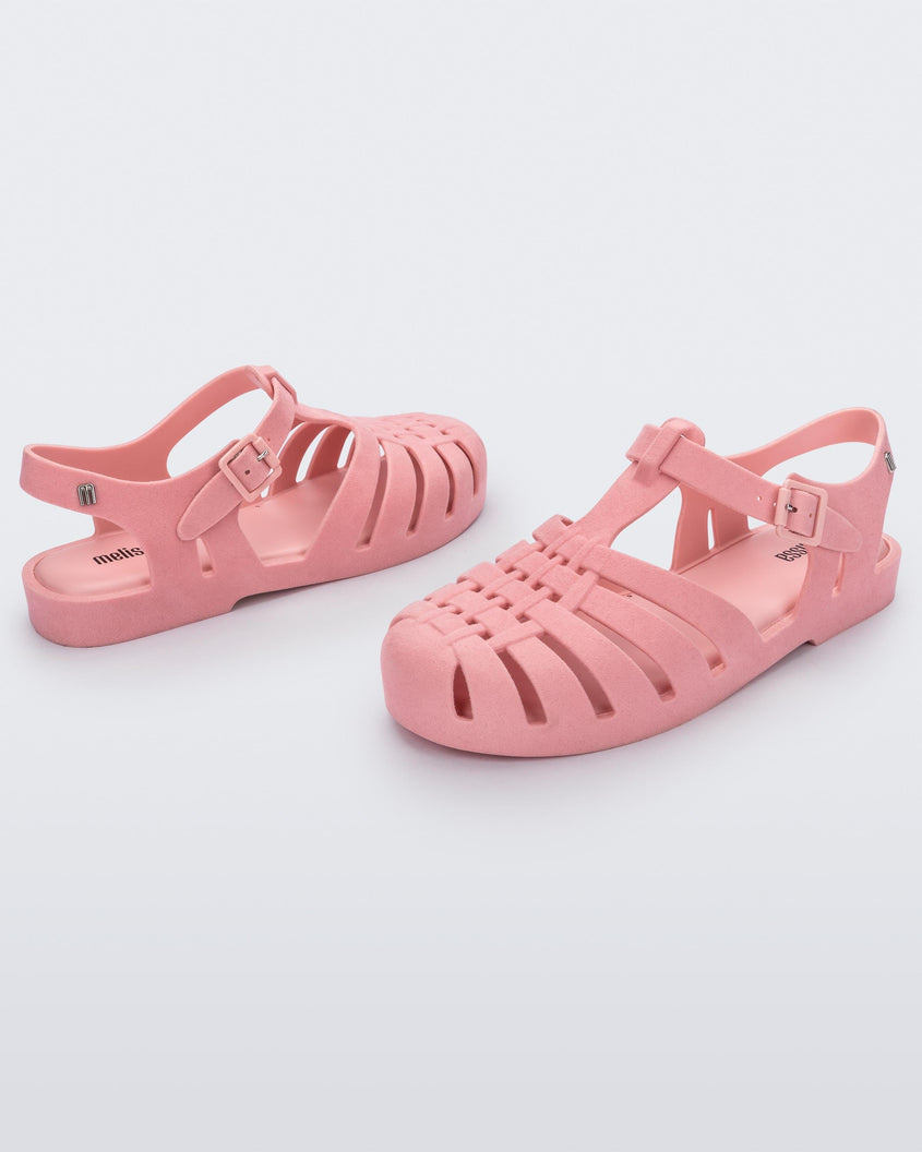 Angled view of a pair pink flocked Melissa Possession Velvet sandals.
