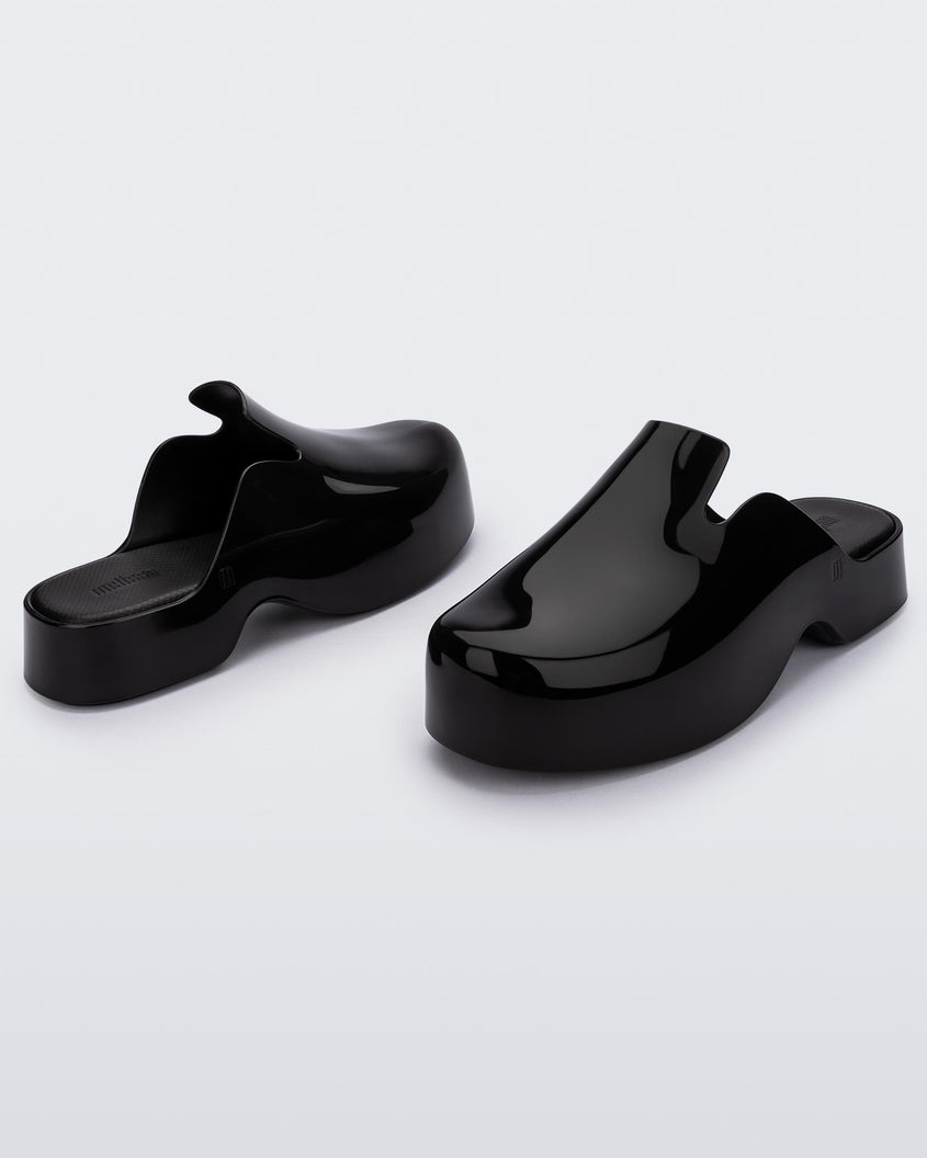 Angled view of a pair of black Melissa Zoe mules.