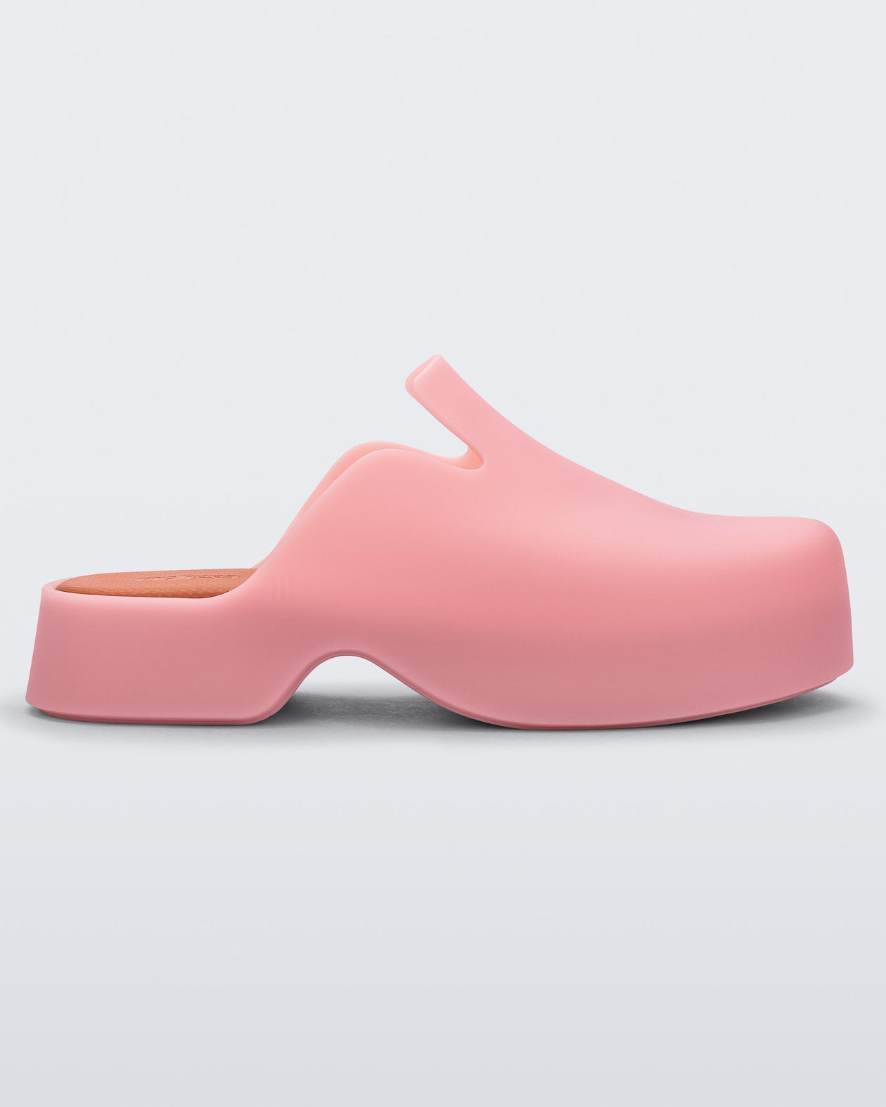 Side view of a pink Melissa Zoe mule and orange insoles.