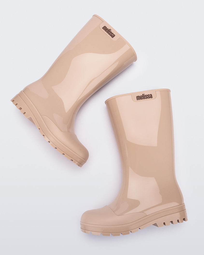 Side view of a pair of beige Melissa Welly boots.