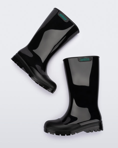 Side view of a pair of black Melissa Welly boots.