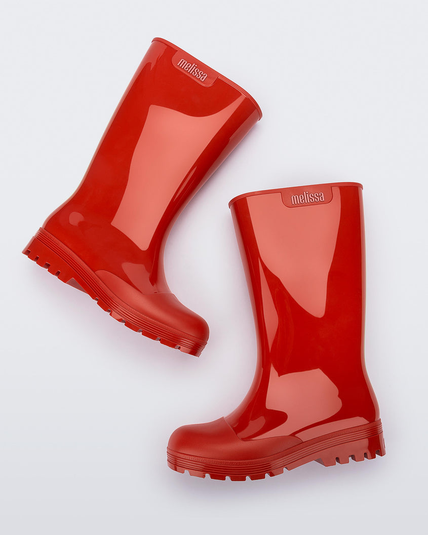 Side view of a pair of red Melissa Welly boots.