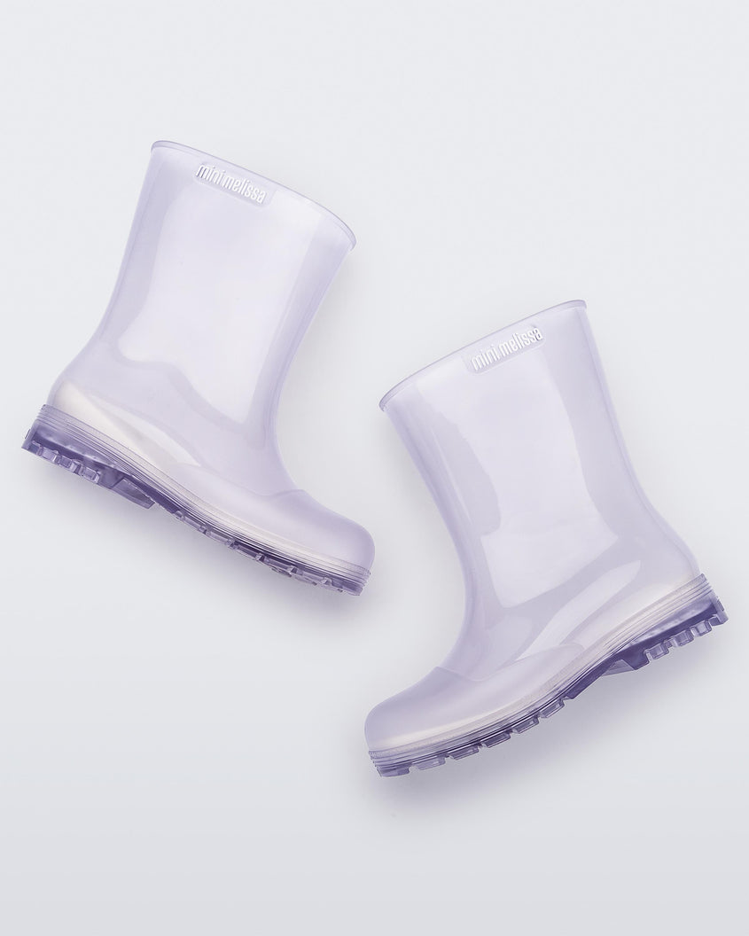 Side view of a pair of clear kids Melissa Welly boots.