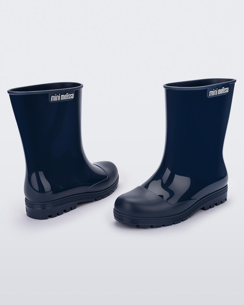 Angled view of a pair of blue kids Melissa Welly boots.