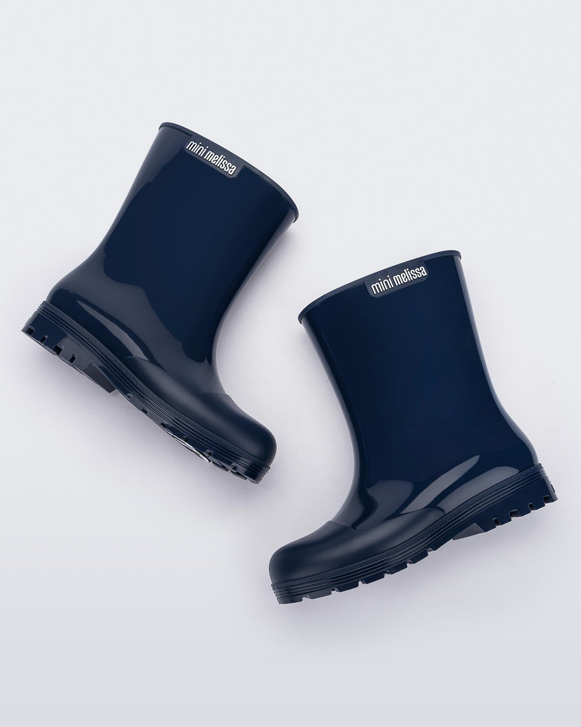 Side view of a pair of blue kids Melissa Welly boots.