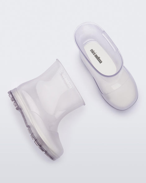 Top and side view of a pair of clear baby Melissa Welly boots.
