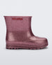 Side view of a glitter pink baby Melissa Welly boot.