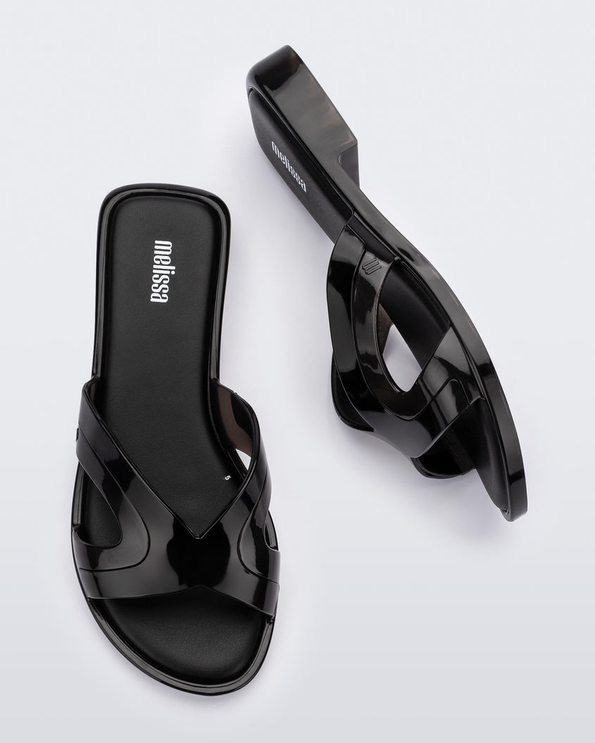 Top and side view of a pair of black Melissa Yacht slides.