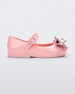 Side view of a pink Mini Melissa Sweet Love baby mary jane flat with a metallic pink bow.