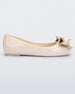 Side view of a beige Mini Melissa Sweet Love kids flat with a gold bow.