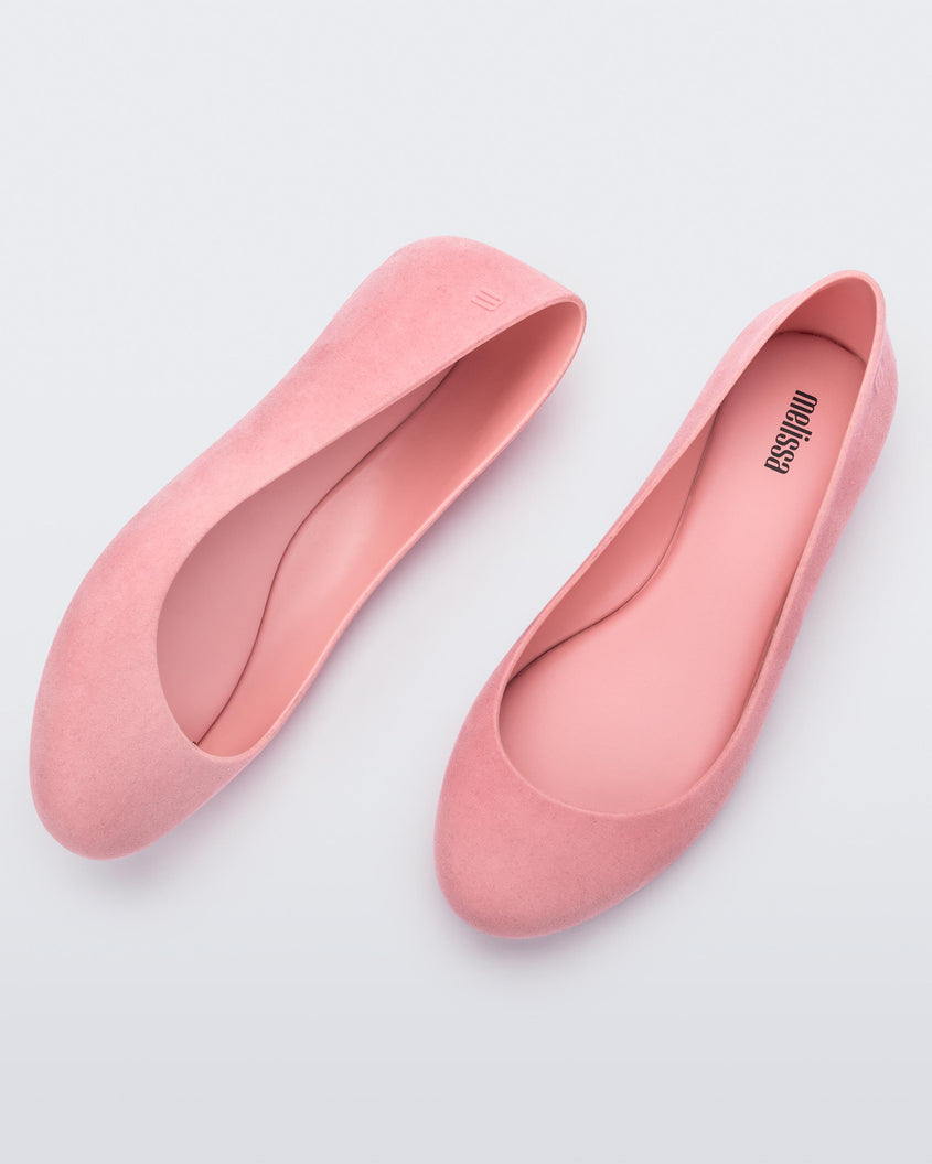 Side and top view of a pair of pink flocked Melissa Sweet Love Basic Velvet flats.
