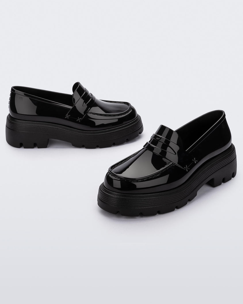 Angled view of a pair of Melissa Royal platform loafers in Black