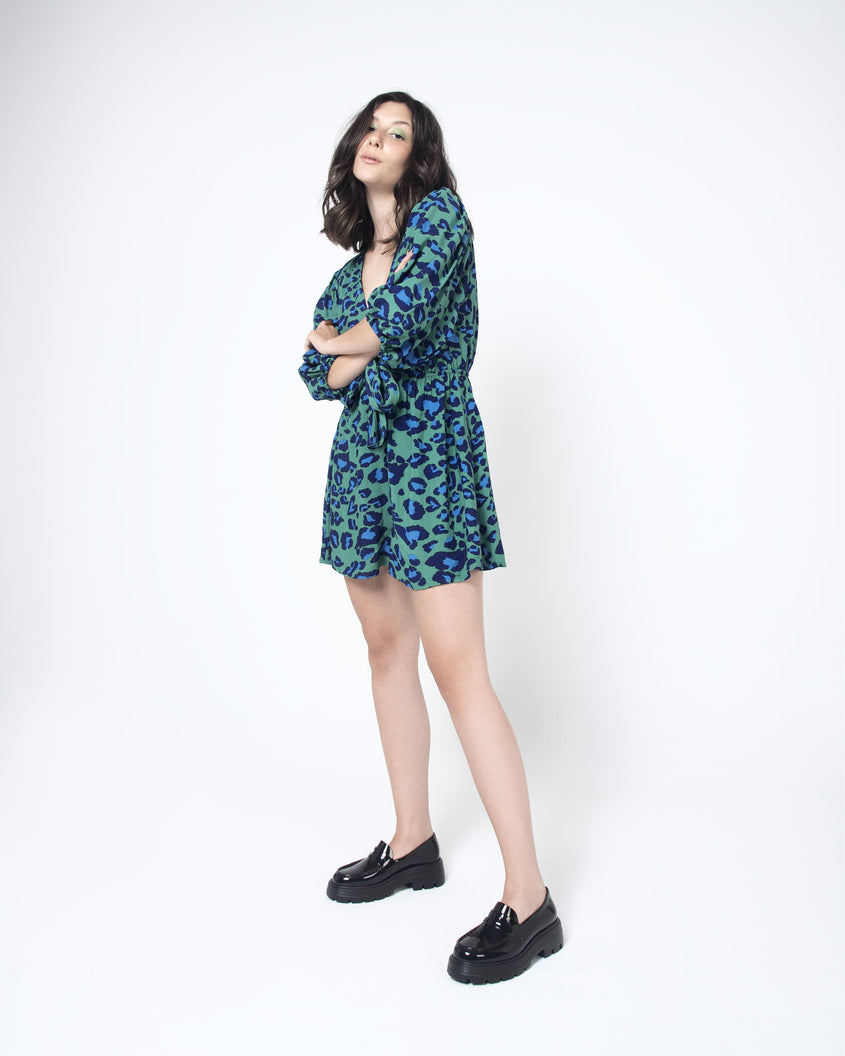 A model posing in a patterned dress wearing a pair of black Melissa Royal platform loafers