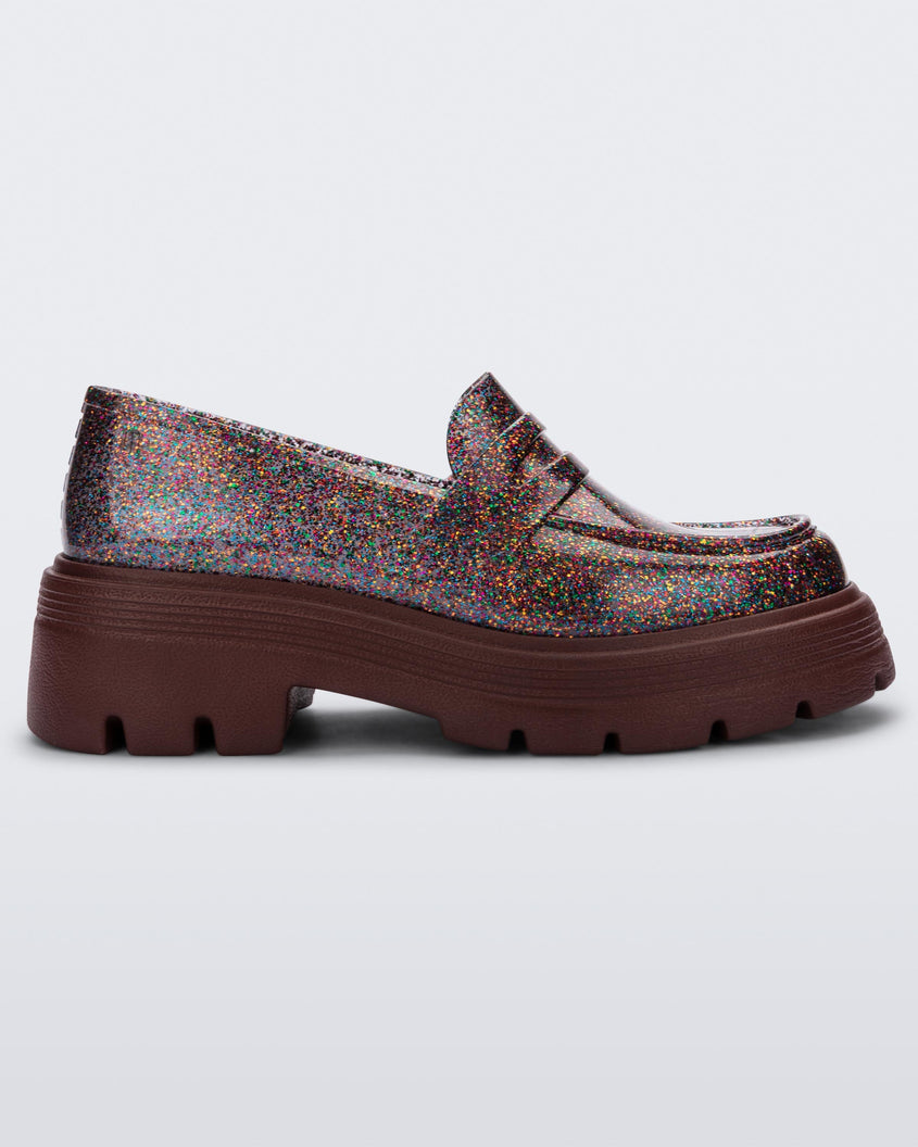 Side view of a Melissa Royal loafer in glitter multicolor with a brown platform sole.