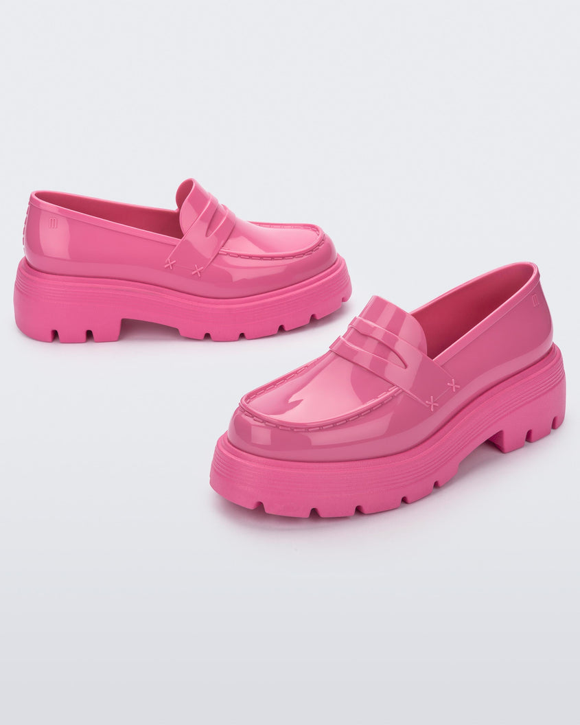Angled view of a pair of Melissa Royal platform loafers in Pink