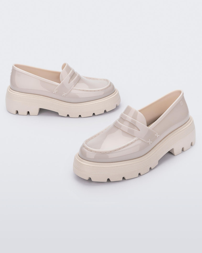 Angled view of a pair of Melissa Royal platform loafers in Beige