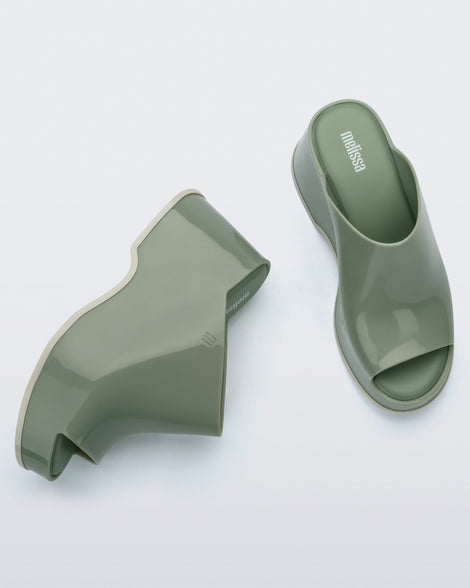 Top and side view of a pair of light green Patty mule platforms.