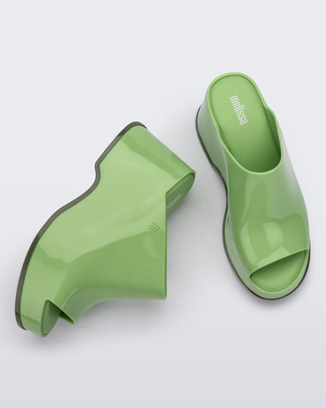 Top and side view of a pair of green Melissa Patty platform mules.