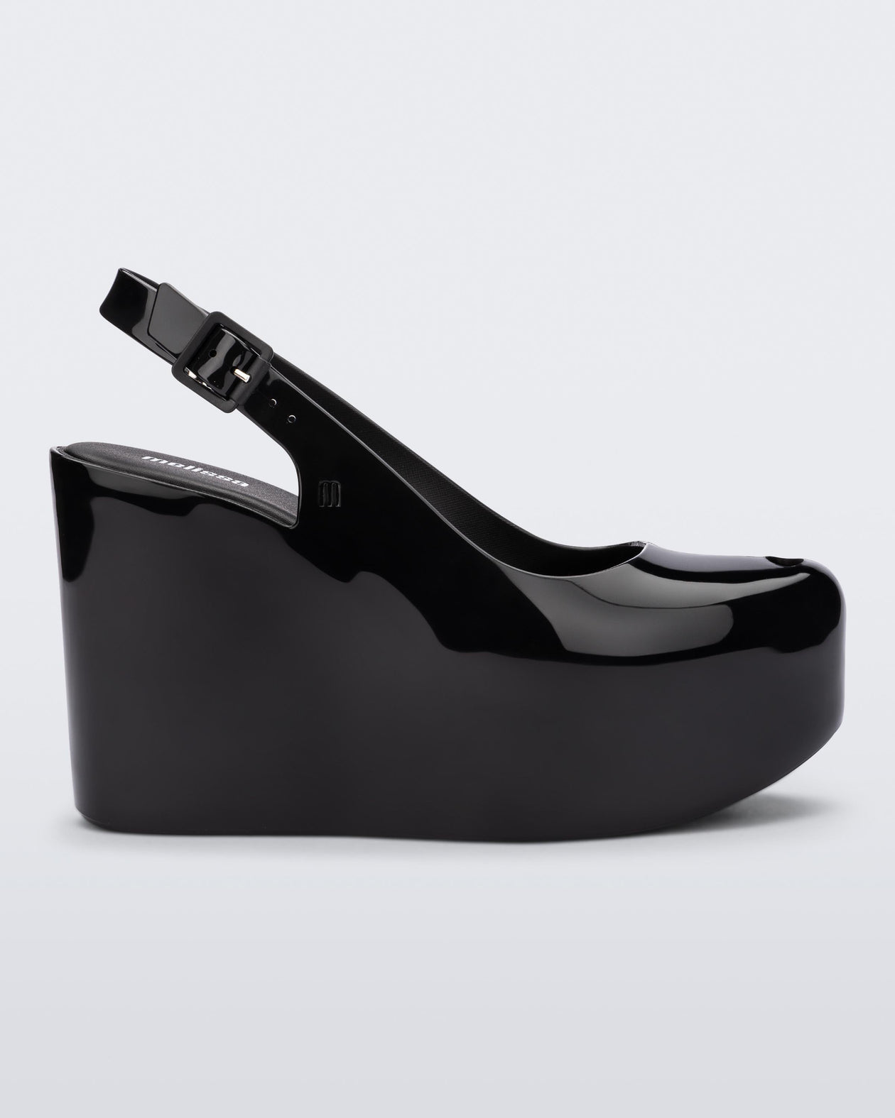 Side view of a black Melissa Groovy wedge platform slingback heel with peep toe. 