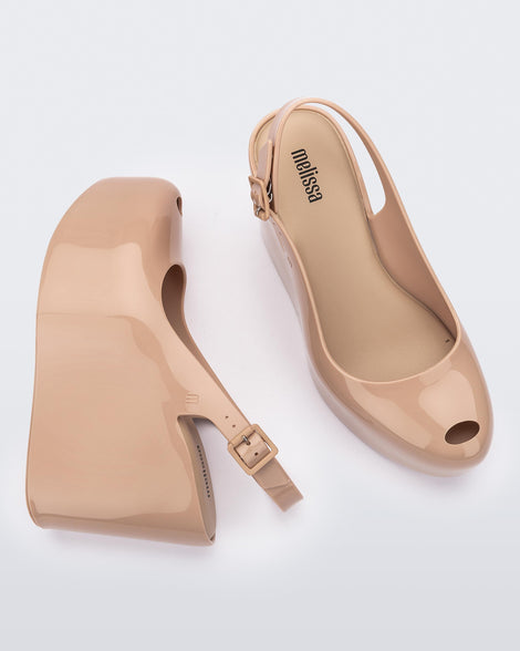Side and top view of a pair of beige Melissa Groovy wedge platform slingback heels with peep toe.