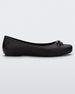 Side view of a black Melissa Aura Basic flat with a black bow.