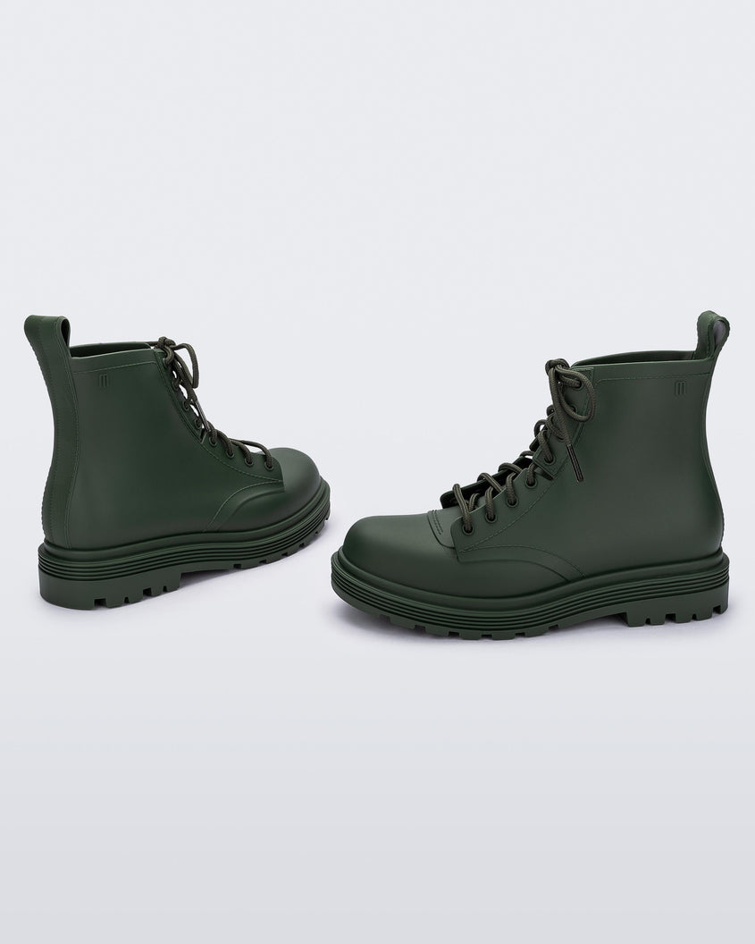Angled view of a pair of green kids Melissa Coturno boots.