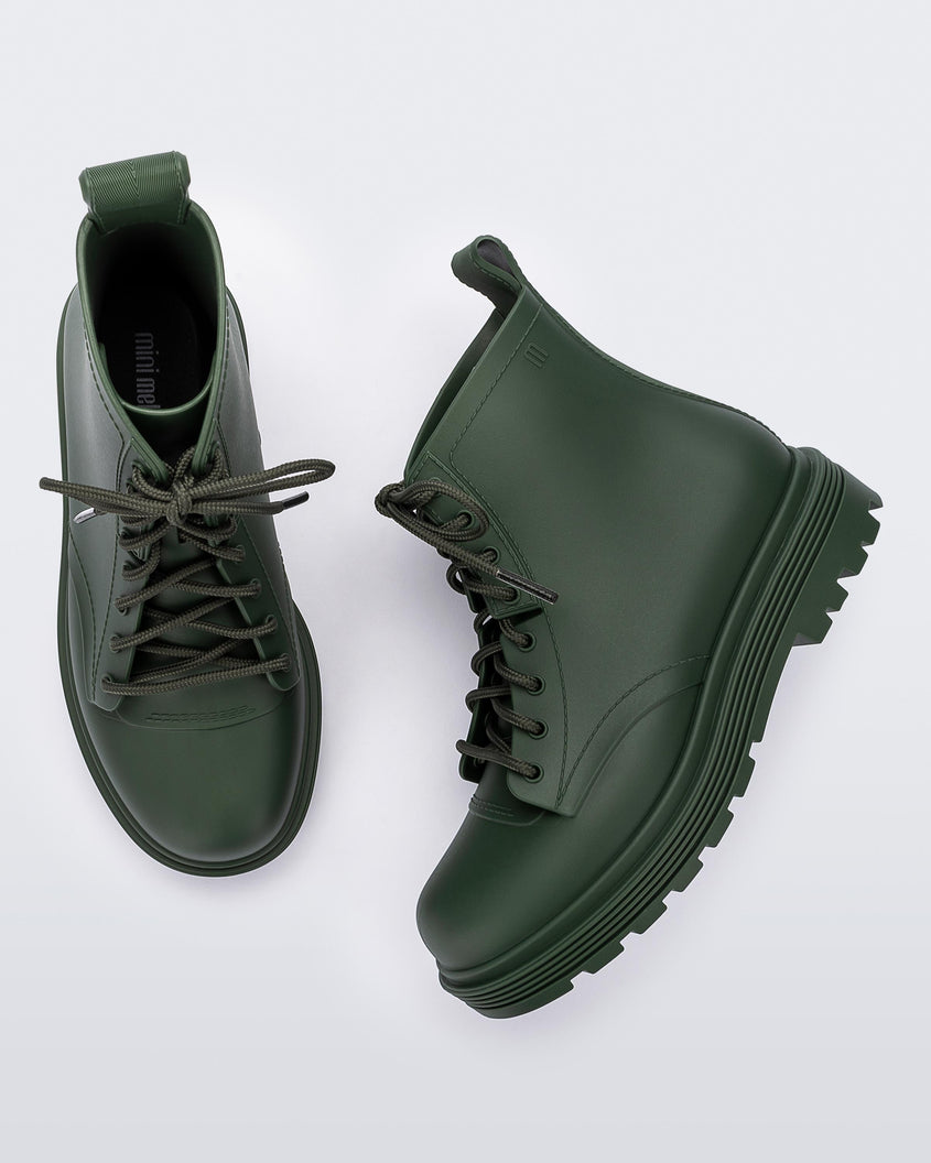 Top and side view of a pair of green kids Melissa Coturno boots.