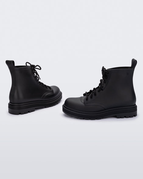 Angled view of a pair of black kids Melissa Coturno boots.