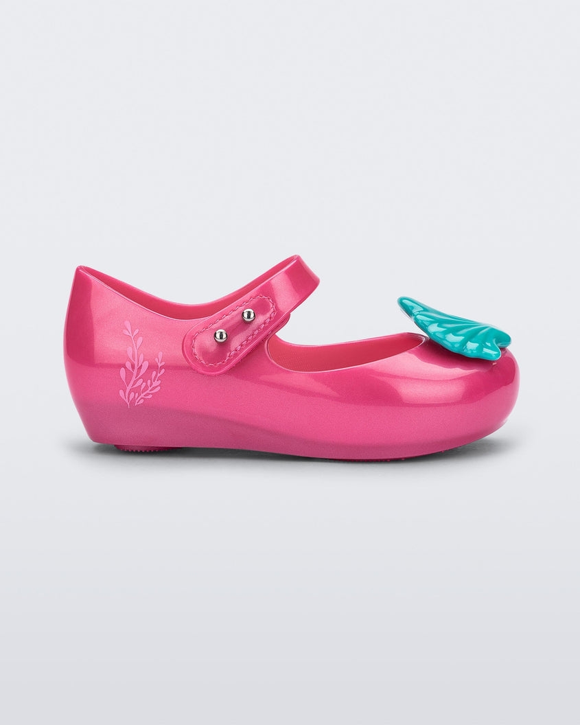 Side view of a pink Mini Melissa Ultragirl + Disney Little Mermaid flat with blue shell on top