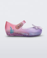 Side view of a transparent pink and purple Mini Melissa Ultragirl + Disney Little Mermaid flat with a pearly white flower on top