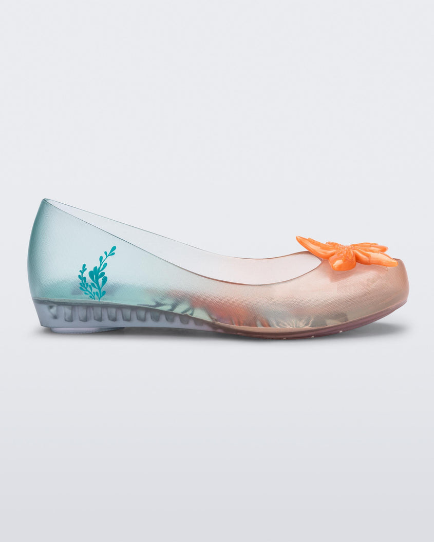 Side view of a transparent green and orange Mini Melissa Ultragirl + Disney Little Mermaid flat with a pearly orange flower on top