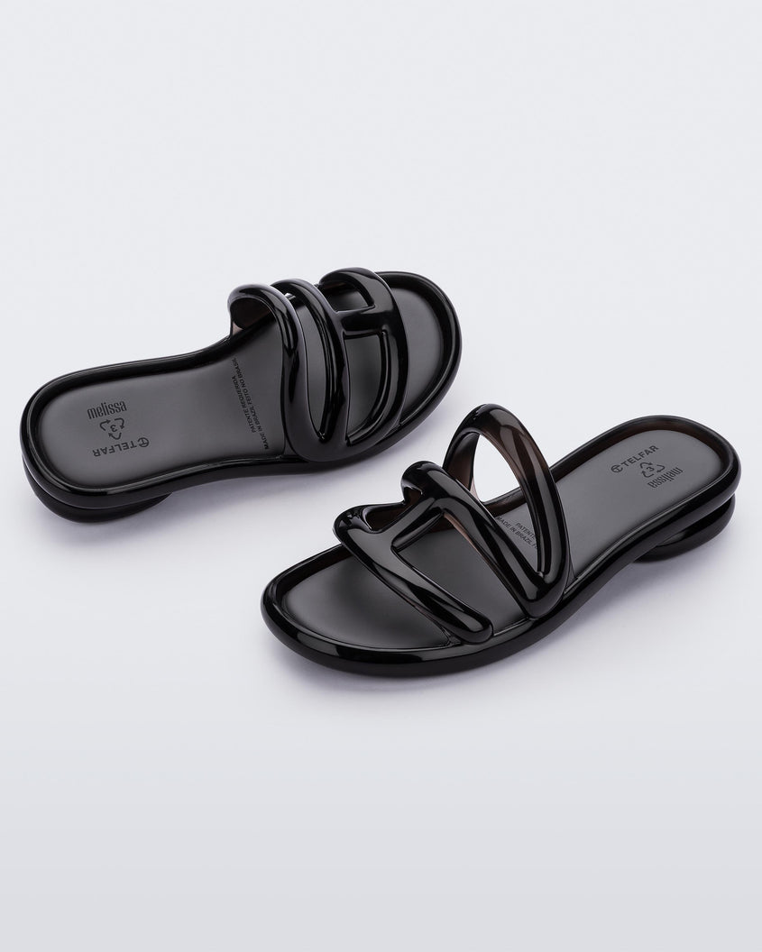 Top angled view of a pair of Melissa Jelly Slides + Telfar in black.