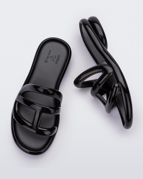 Top and side view of a pair Melissa Jelly Slides + Telfar in black.