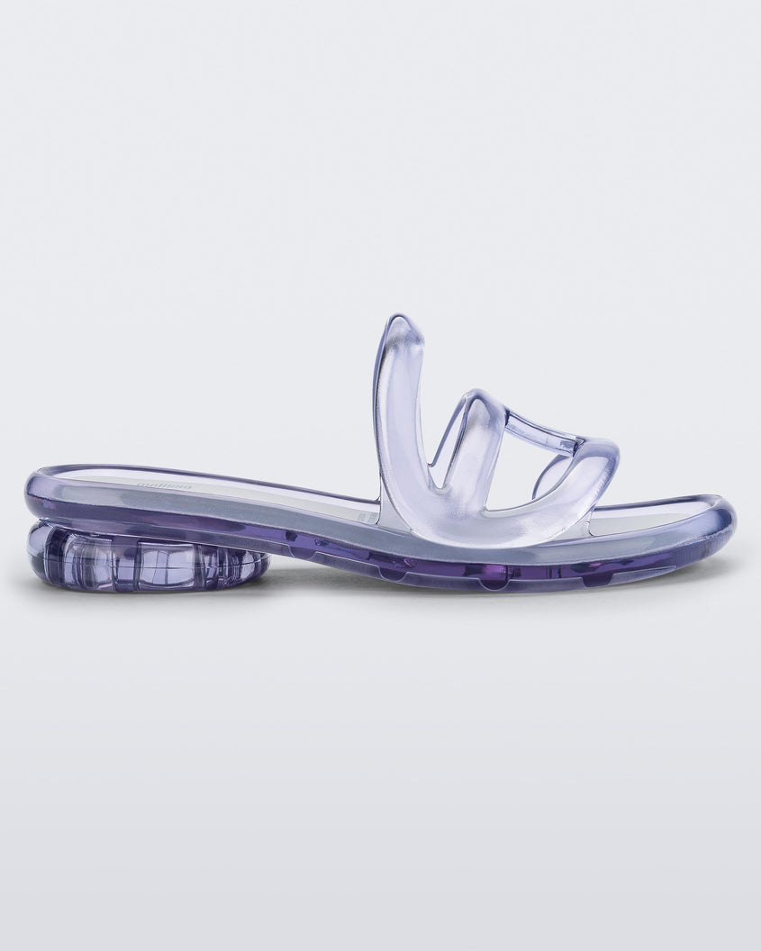 Side view of a Melissa Jelly Slides in Clear with white insole