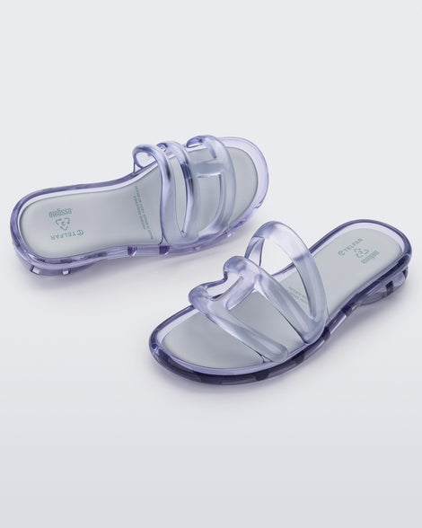 Top and angled view of a pair of Melissa Jelly Slides in Clear with white insole.
