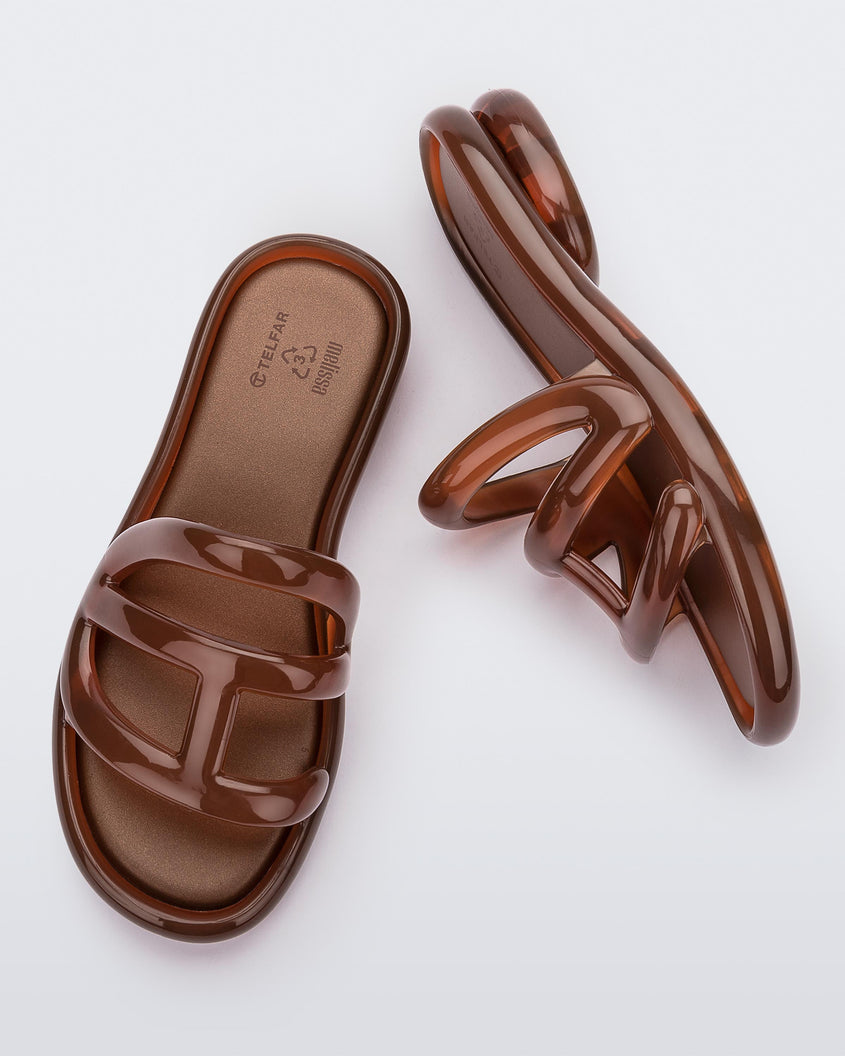 Top and side view of a pair Melissa Jelly Slides + Telfar in brown.