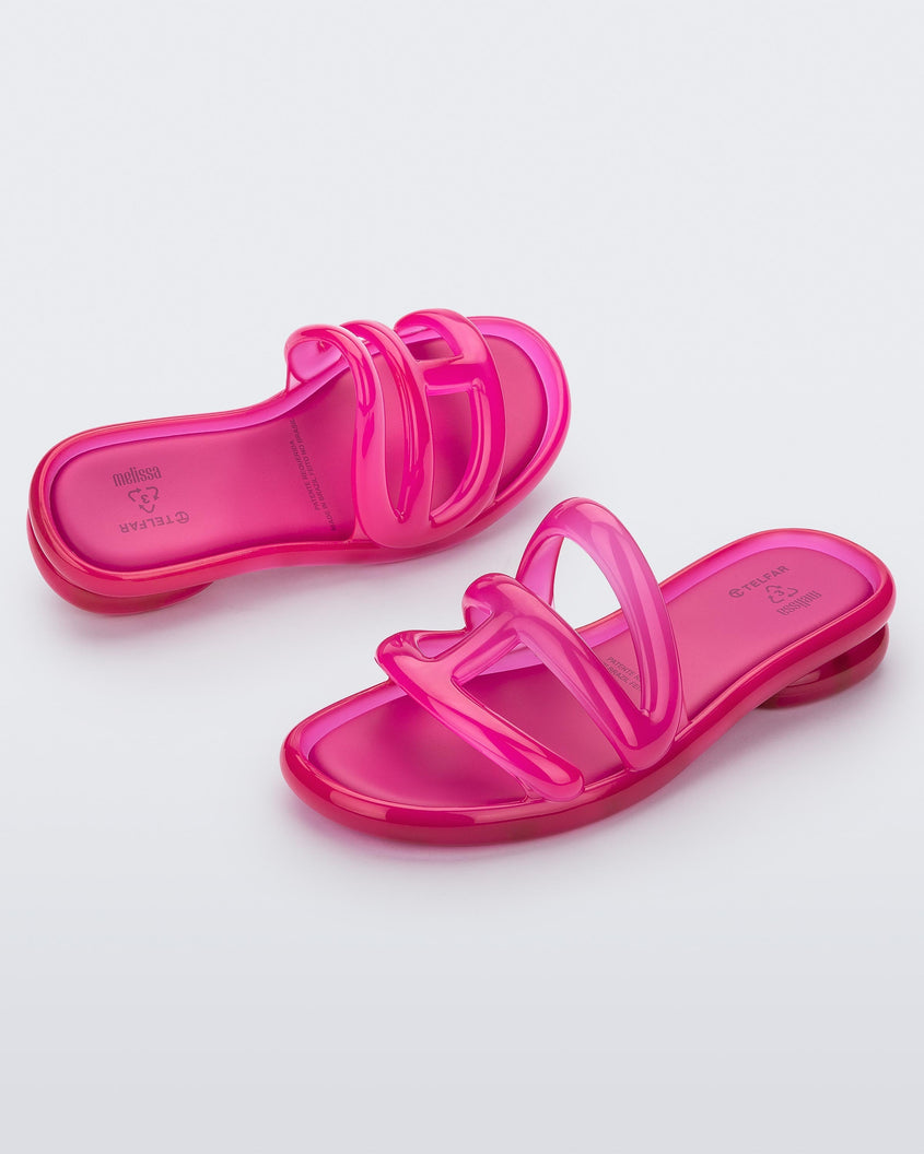 Top angled view of a pair of Melissa Jelly Slides + Telfar in pink.