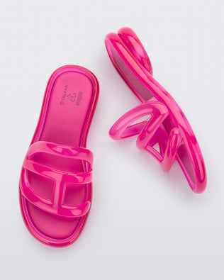 Top and side view of a pair Melissa Jelly Slides + Telfar in pink.