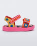 Side view of a pink, red, blue, and yellow patterned Mini Melissa Pula Pula + Fabula sandal.