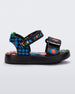 Side view of a black and blue patterned Mini Melissa Pula Pula + Fabula sandal.