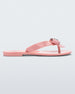 Side view of a pink Melissa Harmonic Heart flip flop with a pink bow and metallic pink heart detail on the straps