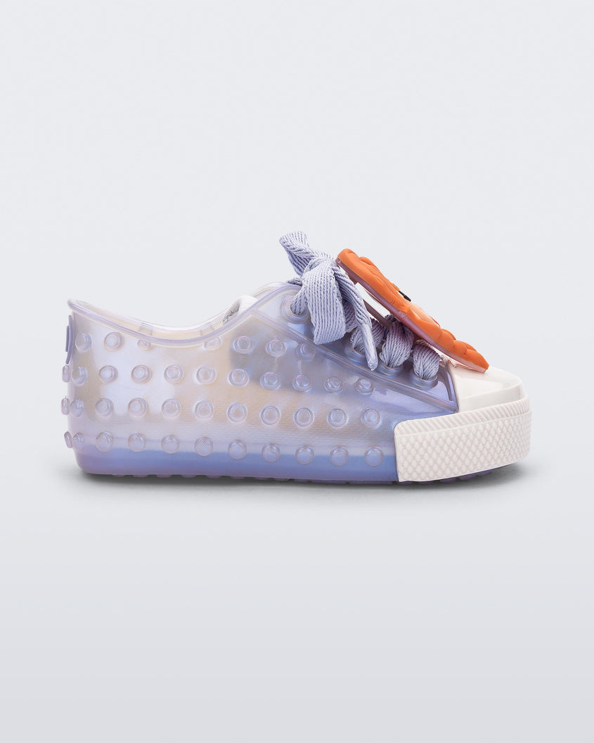 Side view of a baby metallic blue Melissa Polibolha sneakers with a white toe top and Disney Frozen's Anna.
