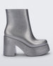 Side view of the silver glitter Melissa Nubia platform heel boot.