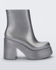Side view of the silver glitter Melissa Nubia platform heel boot.