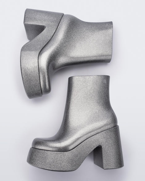 Top view of a pair of silver glitter Melissa Nubia  platform heel boots.