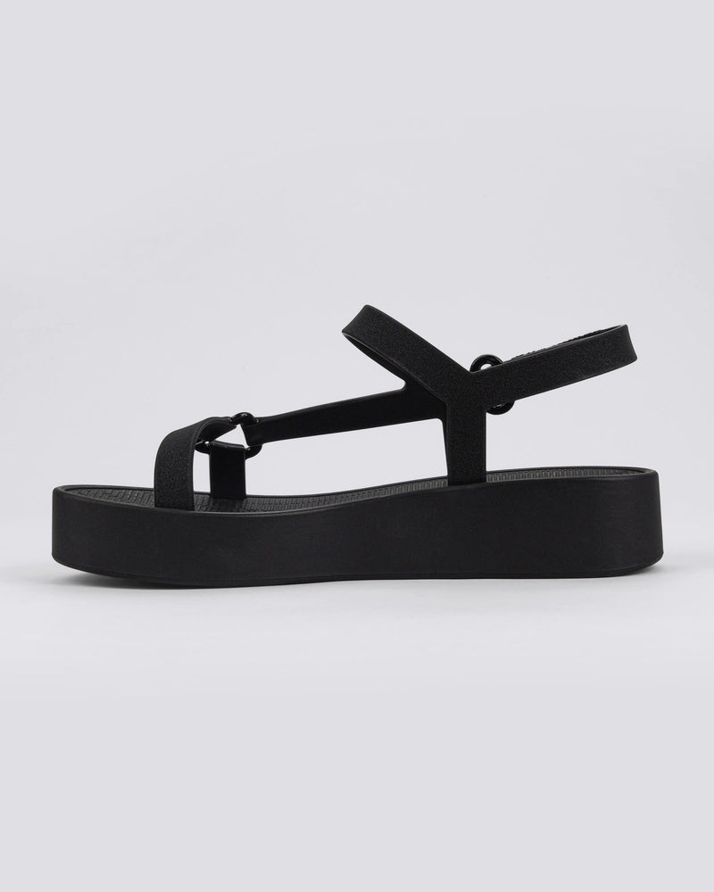 Inner side view of a pair of black Sun Downtown Platform sandals