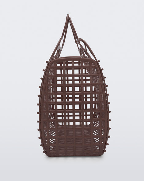 Side view of a brown Refraction bag with handles