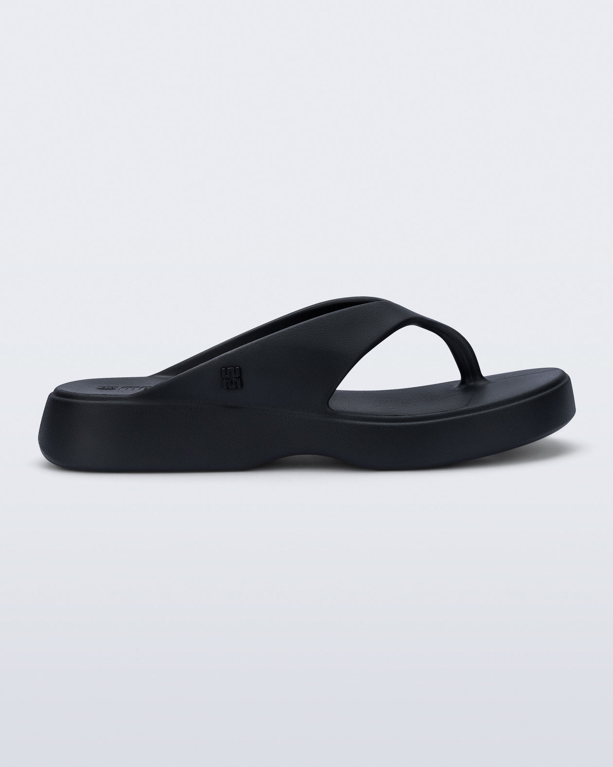 Side view of a black Free Thong Low flip flop