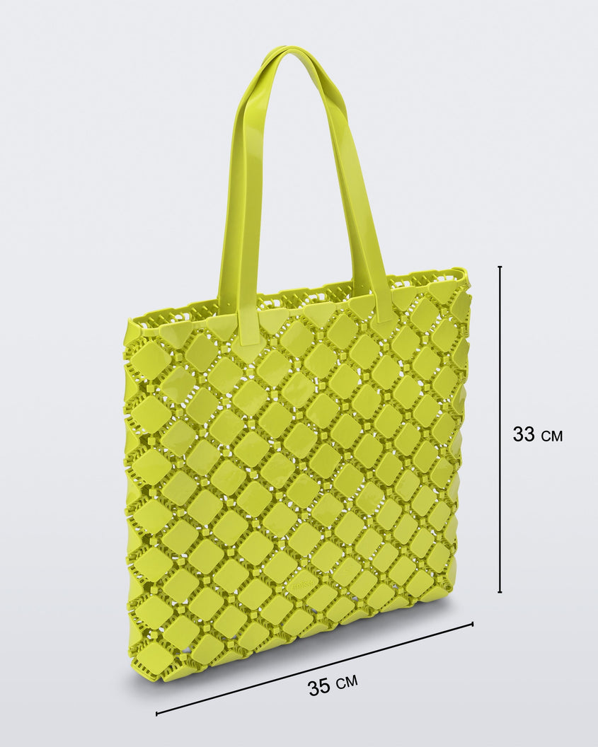 Angled view of a yellow Melissa Mogu + Hikaru Matsumura bag with dimensions 35 cm length and 33 cm height