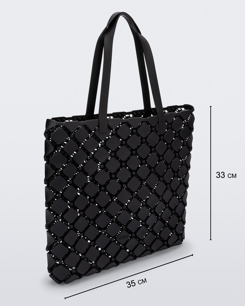 Angled view of a black Melissa Mogu  + Hikaru Matsumura bag with dimensions 35 cm length and 33 cm height